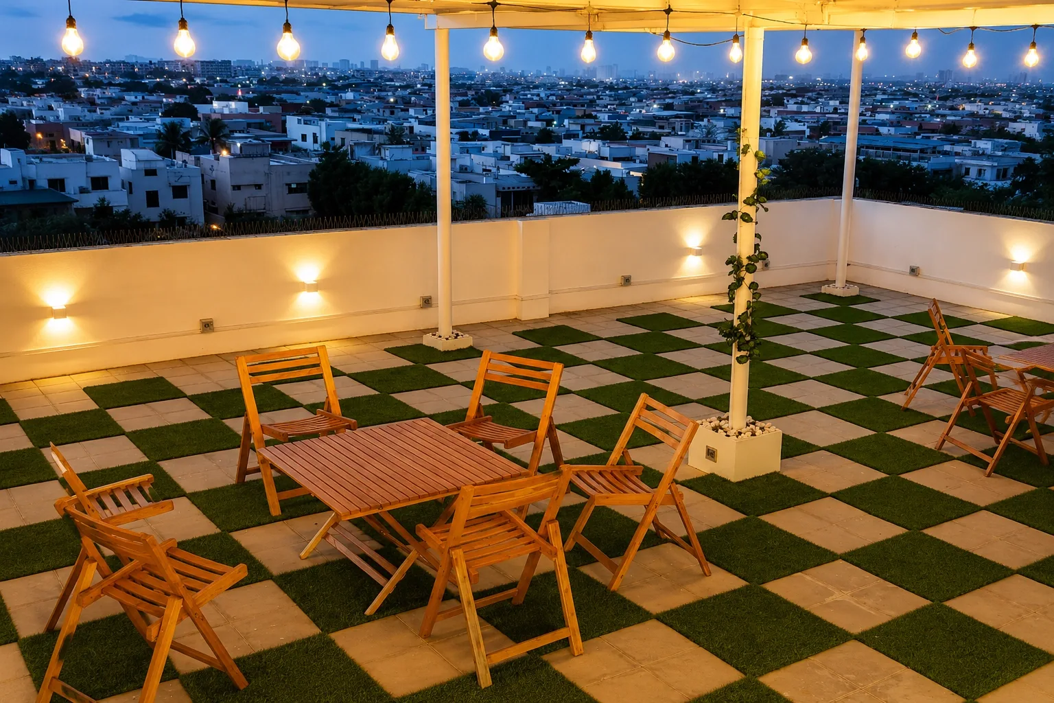 The rooftop SkyView Space at dusk, with festoon lights, wooden tables and the city beyond